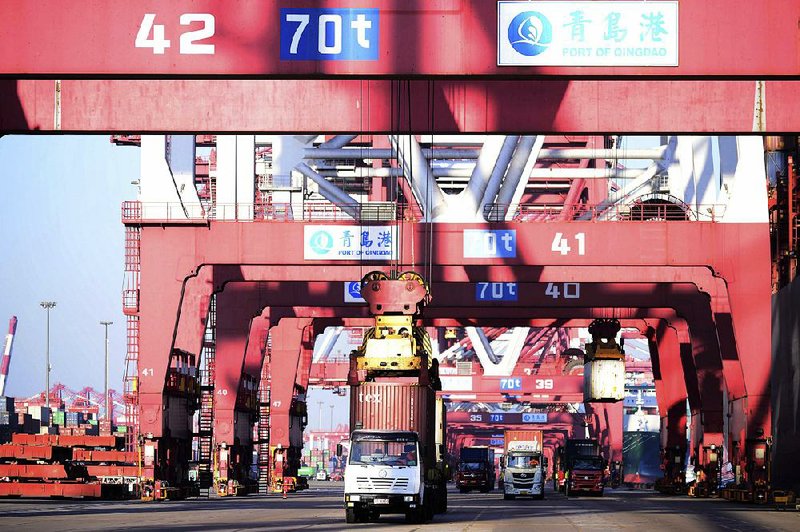Trucks move shipping containers at a port in Qingdao in eastern China’s Shandong province in January. China’s exports rose 11.1 percent in January.