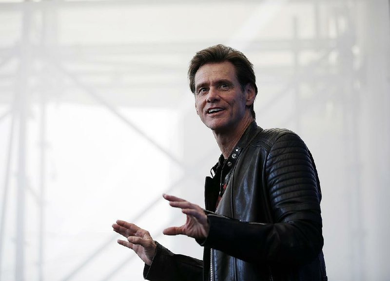 In this Sept. 5, 2017 file photo, actor Jim Carrey poses for photographers during the photo call of the film "Jim & Andy: The Great Beyond - The Story of Jim Carrey & Andy Kaufman Featuring a Very Special, Contractually Obligated Mention of Tony Clifton," at the 74th edition of the Venice Film Festival, in Venice, Italy. 