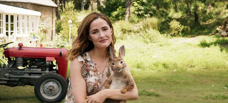 Rose Byrne stars as Bea (a likely stand-in for author Beatrix Potter) in Peter Rabbit, a family comedy based on Potter’s stories that mixes animated animals with live action.