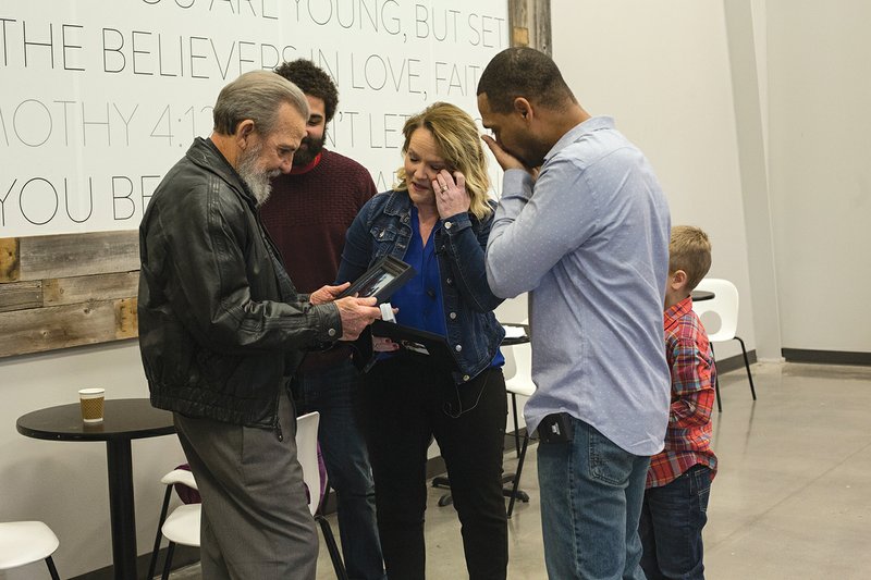 Jack Folts, left, looks at pictures of Evan Cotillier, along with Evan’s parents, Kristy and Rodney, right. Folts received Evan’s left kidney after the boy died following an epileptic attack. The families met for the first time Feb. 3, more than four years after the transplant.