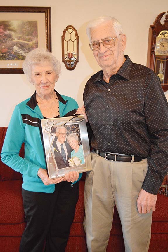 Newlyweds Elsie and Jack Grimes of Guy hold an album of photos from their Sept. 23 wedding. They met on a blind date, arranged by a mutual friend, and were married four months later. They each had been happily married for more than 60 years, and their spouses died within nine days of each other. Matchmaker Donna Treece of Guy said, “The first little date, they seemed very comfortable together. The next thing I know, they’re getting married.”