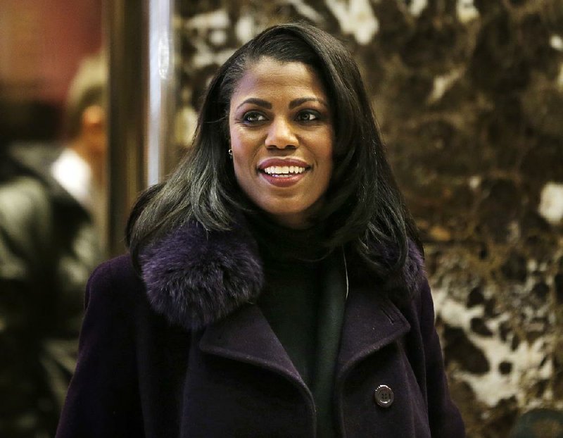 In this Dec. 13, 2016 file photo, Omarosa Manigault smiles at reporters as she walks through the lobby of Trump Tower in New York. Manigault Newman is a cast member on "Celebrity Big Brother," premiering Thursday on CBS.  