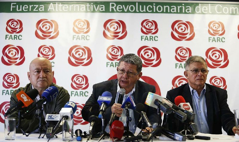 Former Colombian rebels (from left) Carlos Antonio Losada, Pablo Catatumbo and Rodrigo Granda said Friday in Bogota that safety concerns led to them to halt their political campaign.