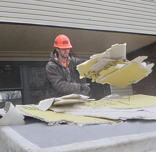 The Sentinel-Record/Richard Rasmussen PROJECT OVERHAUL: Matt Clark of Rall Construction Co. removes old drywall Friday from inside an Eastwood Heights unit of the Hot Springs Housing Authority.