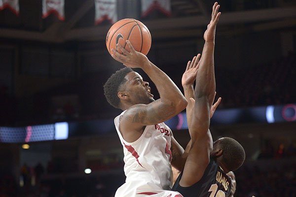 Arkansas' Daryl Macon (left) drives to the basket as he is pressured by Vanderbilt's Maxwell Evans (10) Saturday, Feb. 10, 2018, during the first half of play in Bud Walton Arena in Fayetteville.