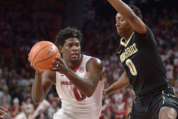 Arkansas' Jaylen Barford (left) drives to the lane as he is pressured by Vanderbilt's Saben Lee Saturday, Feb. 10, 2018, during the first half of play in Bud Walton Arena in Fayetteville. 
