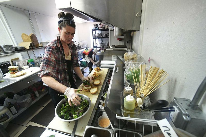 Amber Cafourek-Belasco makes sandwiches at Natural State Sandwiches in downtown Springdale. The owners started the business in a food truck before moving into their current location on Emma Avenue.