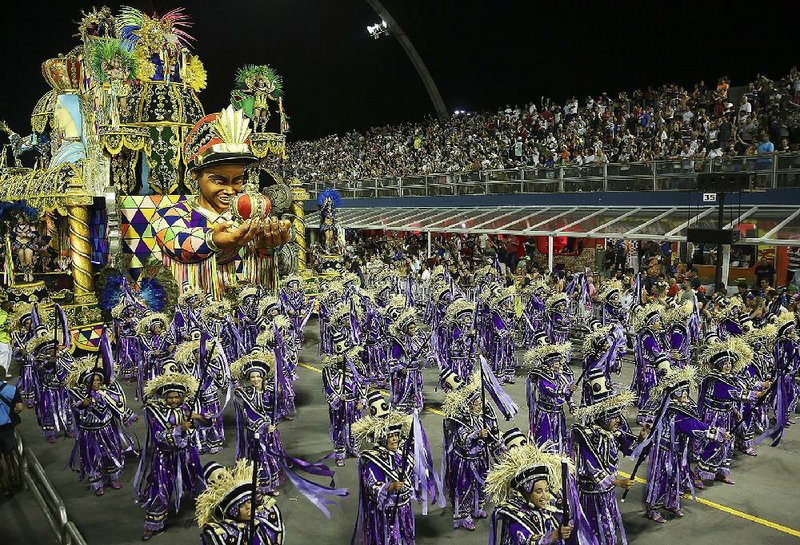 Dancers from the Unidos do Peruche samba school perform Saturday during a Carnival parade in Sao Paulo.