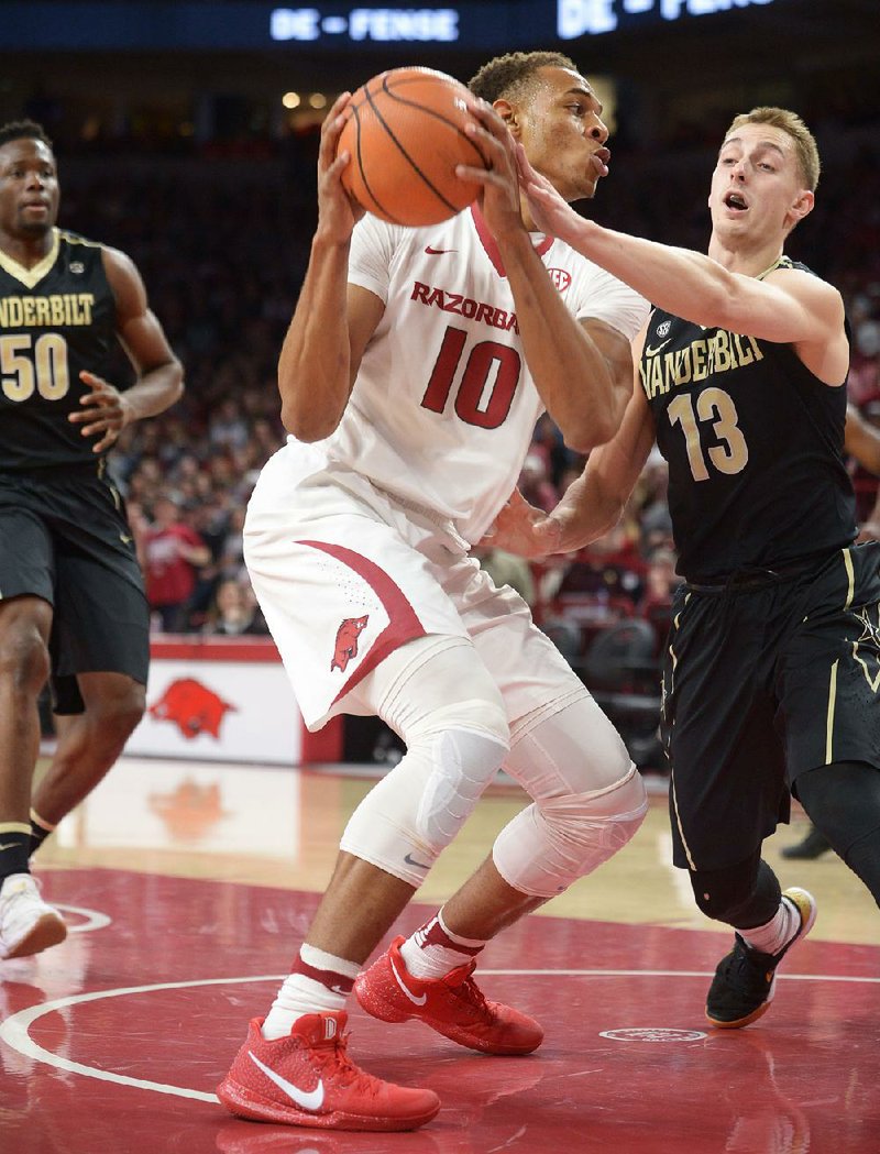 Arkansas’ Daniel Gafford (10) tries to put up a shot against the defense of Vanderbilt’s Riley LaChance during the Razorbacks’ 72-54 victory over the Commodores on Saturday at Walton Arena in Fayetteville. Gafford finished with 16 points.