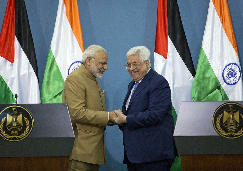 Palestinian President Mahmoud Abbas (right) shakes hands with Indian Prime Minister Narendra Modi on Saturday after meeting at the Palestinian Authority headquarters in the West Bank city of Ramallah.