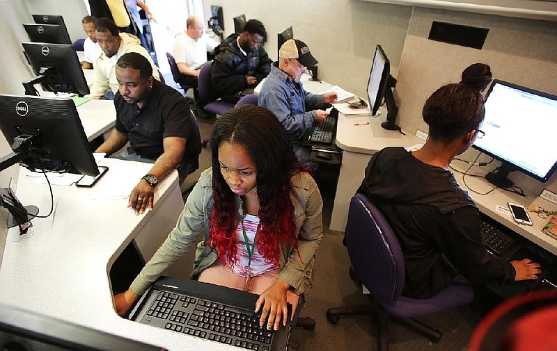 Arkansas Democrat-Gazette/THOMAS METTHE -- 2/10/2018--
Katelyn Penn, 16, fills out an application for a job during the city of Little Rock's Citywide Career Fair on Saturday, Feb. 10, 2018 at the Southwest Community Center. Penn was looking for part-time employment, but the career fair offered both full and part-time jobs as well as summer employment opportunities. 