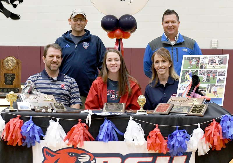 Bud Sullins/Special to Siloam Sunday Siloam Springs senior Audrey Maxwell signed to play soccer Wednesday at Rogers State University in Claremore, Okla. Pictured are: Front from left, father Joel Maxwell, Audrey Maxwell, mother Amy Maxwell; back, Arkansas Comets coach Bill Bernie and Siloam Springs head coach Brent Crenshaw.
