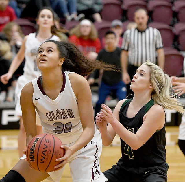 Bud Sullins/Special to Siloam Sunday Siloam Springs junior Emery Brown gets ready to shoot as Alma's Cassidy Cooper defends on the play. Siloam Springs rallied to beat Alma 49-45 on Wednesday inside the Panther Activity Center.