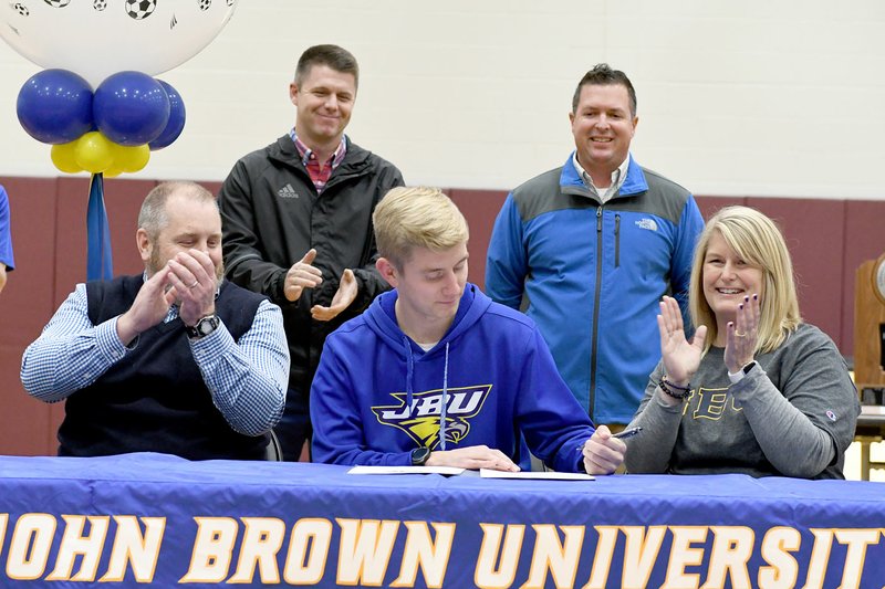 Bud Sullins/Special to Siloam Sunday Siloam Springs senior Jack Bos signed Wednesday to play soccer at John Brown University in Siloam Springs. Pictured are: Front from left, father Stephen Bos, Jack Bos, mother Holly Bos; back, John Brown men's coach Brenton Benware and Siloam Springs head coach Brent Crenshaw.