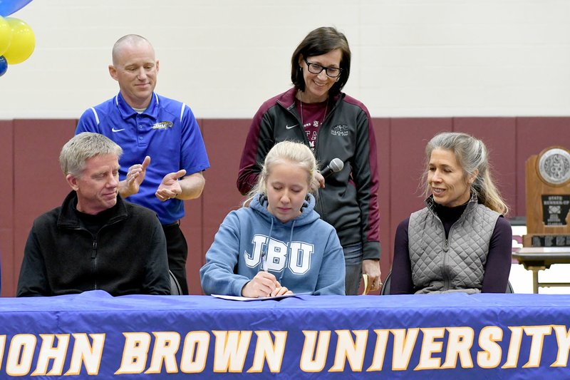 Bud Sullins/Special to Siloam Sunday Siloam Springs senior Allika Pearson signed Wednesday to run cross country at John Brown University in Siloam Springs. Pictured are: Front from left, father Matt Pearson, Allika Pearson, mother Kirsten Pearson; back, JBU head coach Scott Schochler and Siloam Springs head cross country coach Sharon Jones.