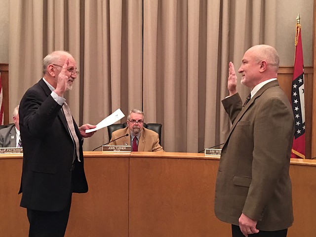 Courtesy photo Reid Carroll, right, is sworn in as the newest member of the Siloam Springs Board of Directors after winning a runoff election last month.