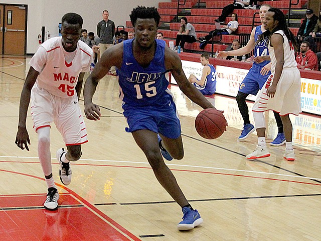 Photo courtesy of Mid-America Christian John Brown freshman Densier Carnes drives to the basket against Mid-America Christian on Thursday in Oklahoma City. The Evangels defeated the Golden Eagles 89-66.