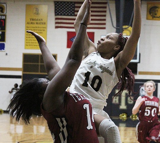 Hot Springs' Ariana Guinn (10) shoots a hoop past Texarkana defender on Friday nights game in Trojan Fieldhouse. (The Sentinel Record/Rebekah Hedges)