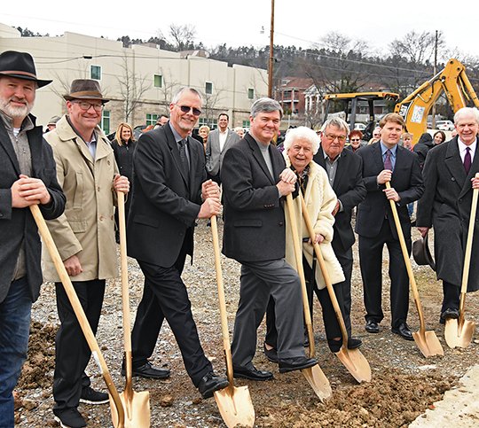 The Sentinel-Record/Grace Brown - Tim Wilson, Brian Hill, Rev. David Moseley, Latt Bachelor, Mildred Smith, Winston Smith, Beau Durbin and Carl Crow break ground at the future site of a park located on the northeast corner of the intersection of Central and Grand avenues. 