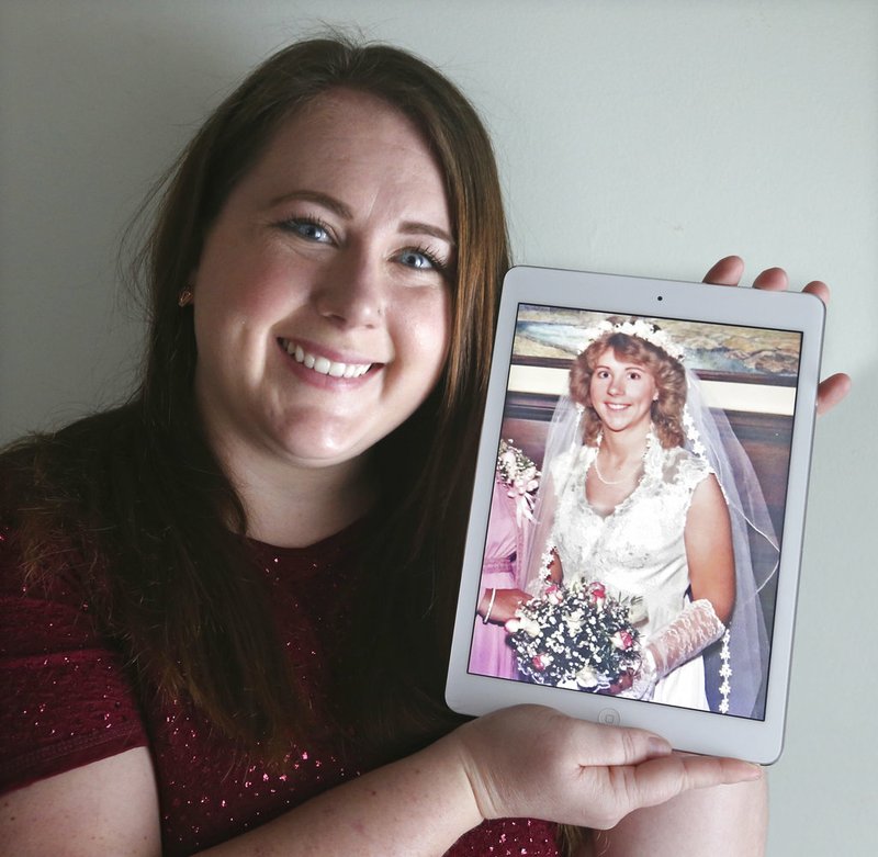 Ame Bartlebaugh holds a 1980 photo of her mother in her wedding dress in Willowick, Ohio. 