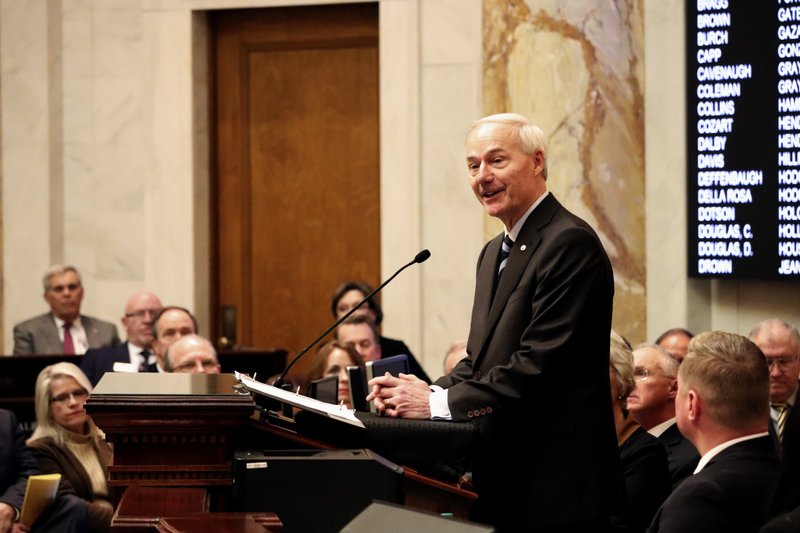 The Associated Press HUTCHINSON SPEAKS: Arkansas Gov. Asa Hutchinson speaks to a joint session of legislators, Monday at the state Capitol in Little Rock, Ark. The governor told lawmakers that, next year, he would like them to cut the state's top income tax rate from 6.9 percent to 6 percent, a move that would save Arkansas' top earners $180 million annually.