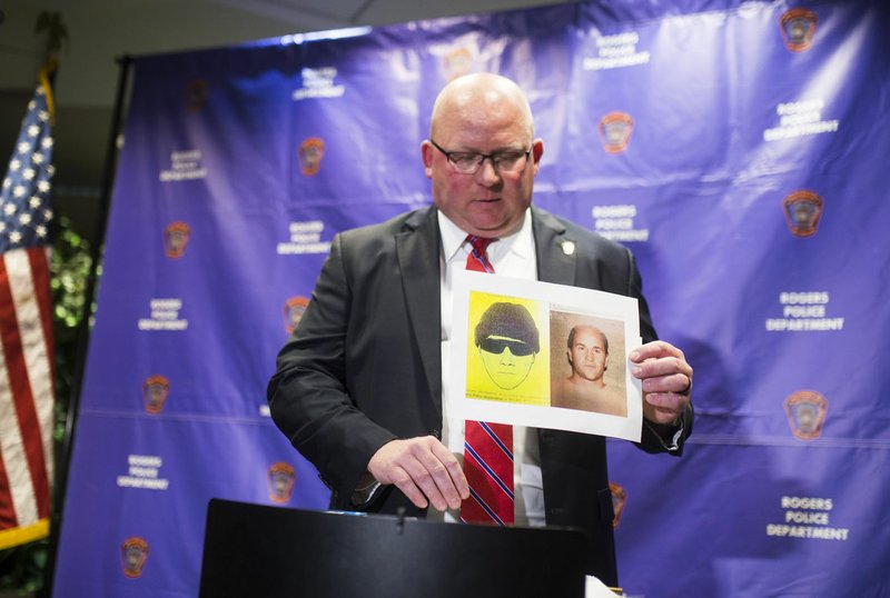 Rogers Police Chief Hayes Minor holds up a picture of Grant Hardin, a suspect in a cold case, during a press conference Monday at the Rogers Police Station in Rogers. Hardin was arrested Monday in connection with the 1997 rape of a Rogers school teacher.