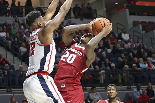 Arkansas forward Darious Hall (20) shoots as Mississippi forward Bruce Stevens (12) defends during the second half of an NCAA college basketball game in Oxford, Miss., Tuesday, Feb. 13, 2018. (Petre Thomas/The Oxford Eagle via AP)

