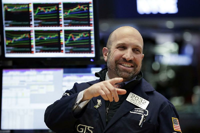 Specialist James Denaro works on the floor of the New York Stock Exchange on Monday, when stocks rallied and the market clawed back some of its big losses from last week. The Dow Jones industrial average climbed 410 points.