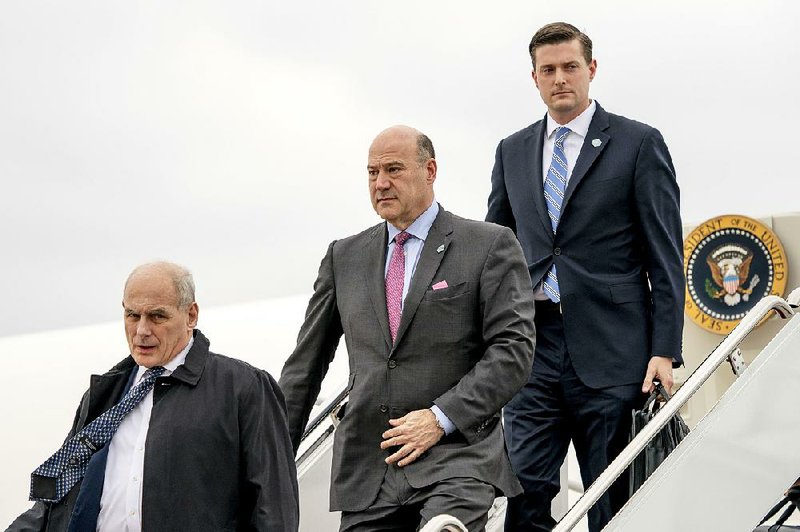 President Donald Trump's Chief of Staff John Kelly, left, White House chief economic adviser Gary Cohn, center, and then White House Staff Secretary Rob Porter, right, arrive at Andrews Air Force Base, Md., Thursday, Feb. 1, 2018.