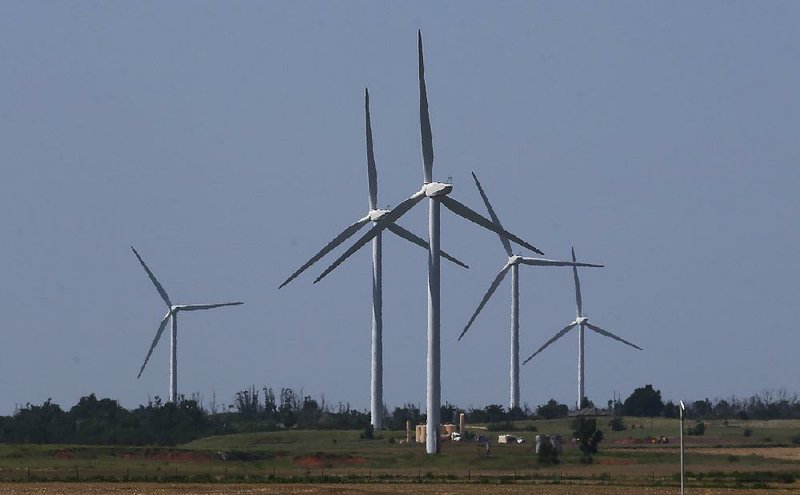 Wind turbines are pictured near El Reno, Okla., last spring. Oklahoma has encouraged the growing wind-generation industry over the past 15 years with tax breaks and other incentives, but state budget deficits have prompted legislators to reverse course, and they are now looking to impose a new production tax on the industry.