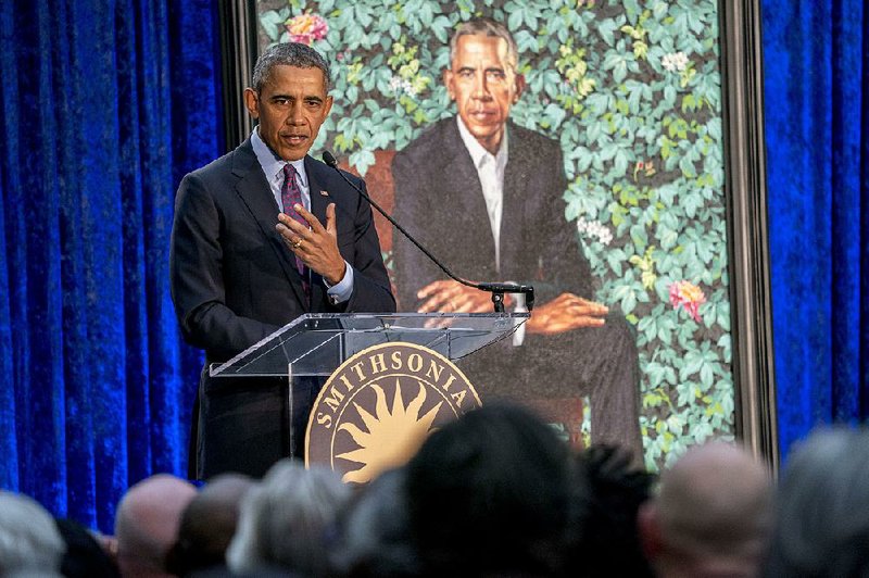 Former President Barack Obama, left, speaks at the unveiling ceremony for the Obama's official portraits at the Smithsonian's National Portrait Gallery, Monday, Feb. 12, 2018, in Washington. Obama's portrait was painted by Artist Kehinde Wiley. 