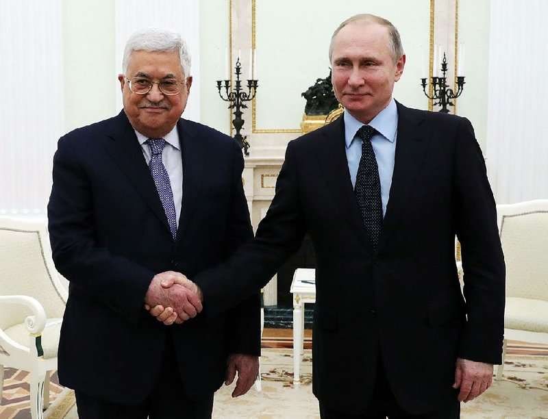 Russian President Vladimir Putin, right, shakes hands with Palestinian President Mahmoud Abbas, during their meeting in the Kremlin in Moscow, Russia, Monday, Feb. 12, 2018. 