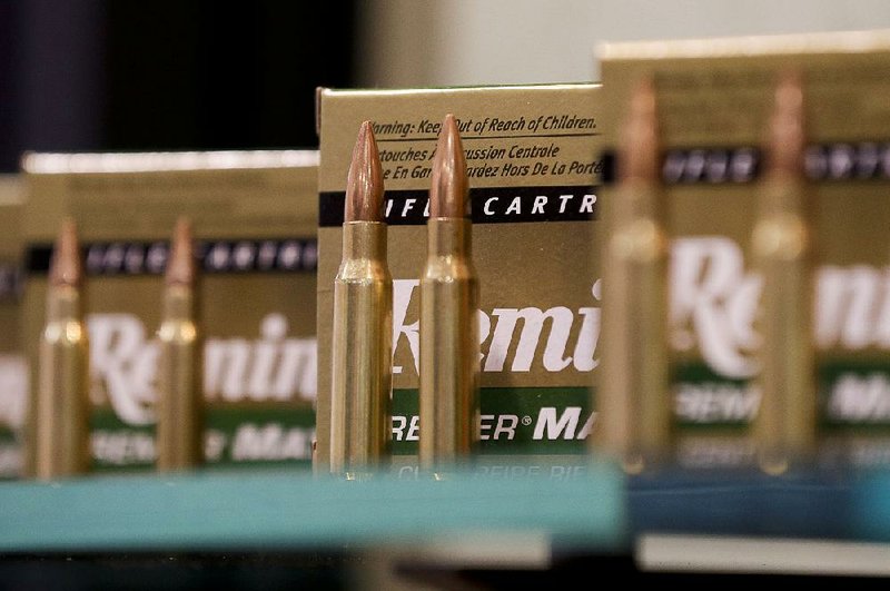 Remington rifle cartridges are displayed at the 35th annual SHOT (Shooting, Hunting and Outdoor Trade) Show in Las Vegas. Remington said Monday it has reached a deal that would allow it to continue operating as it files for Chapter 11 bankruptcy protection.