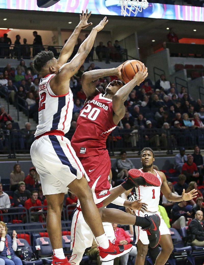 Arkansas forward Darious Hall (20) tries to shoot over Mississippi forward Bruce Stevens during the second half of Tuesday’s victory in Oxford, Miss. Hall tied a season high with 14 points and grabbed 11 rebounds in the victory. 
