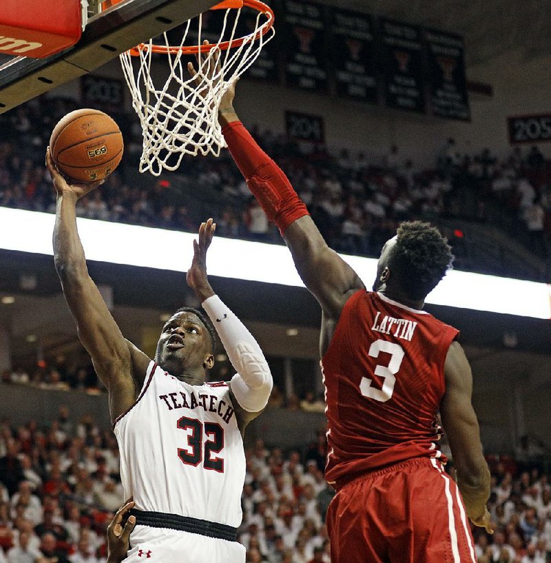 Texas Tech’s Norense Odiase (32) shoots a layup in front of Oklahoma’s Kadeem Lattin on Tuesday during the No. 7 Red Raiders’ 88-78 victory over the No. 23 Sooners in Lubbock, Texas. 