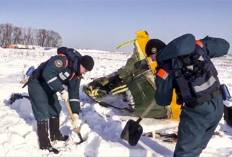 An emergency team searches for wreckage Tuesday at the scene of a plane crash in Stepanovskoye, Russia, in this photo provided by the Russian Emergency Situations Ministry. 