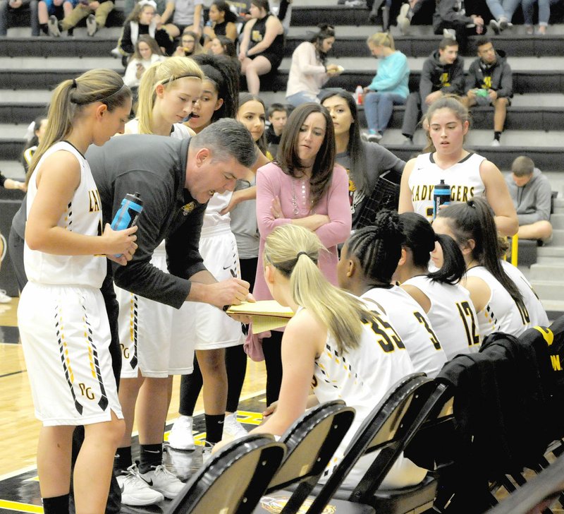 MARK HUMPHREY ENTERPRISE-LEADER Prairie Grove coach Kevin Froud outlines assignments during a break in the action. Froud got the Lady Tigers competing for seeding position in the district tournament. Following a 55-46 defeat at Gentry on Jan. 19, he applauded the Lady Tigers as they rebounded by upsetting Gravette, 54-52, at home Jan. 23.