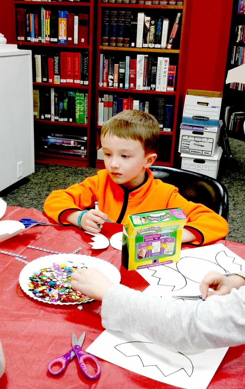 Photo submitted Blaine Wooldridge works on a craft during Elementary Storytime. Elementary Storytime begins at 5 p.m. every Tuesday at the Library.