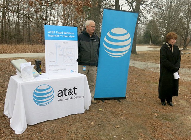 Westside Eagle Observer/SUSAN HOLLAND Cathy Foraker, AT&amp;T director of external affairs (right), announces expanded high-speed Internet access to rural areas of Benton County. Ron Anderson, area manager for planning and engineering, displays an information board showing how the AT&amp;T Fixed Wireless Internet system works. The announcement was made Tuesday afternoon, Feb. 6, in the parking lot at the Mount Pleasant Missionary Baptist Church.