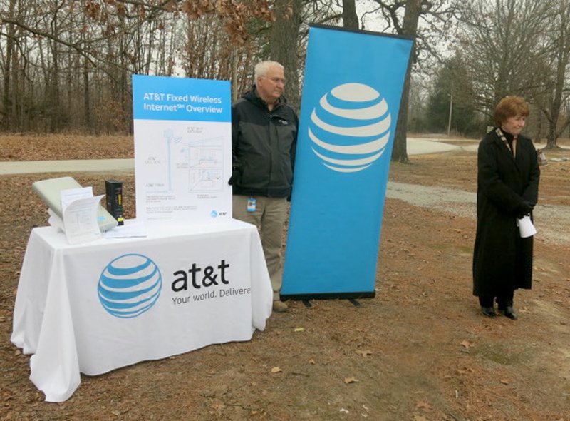 Westside Eagle Observer/SUSAN HOLLAND Cathy Foraker, AT&amp;T director of external affairs (right), announces expanded high-speed Internet access to rural areas of Benton County. Ron Anderson, area manager for planning and engineering, displays an information board showing how the AT&amp;T Fixed Wireless Internet system works. The announcement was made Tuesday afternoon, Feb. 6, in the parking lot at the Mount Pleasant Missionary Baptist Church.