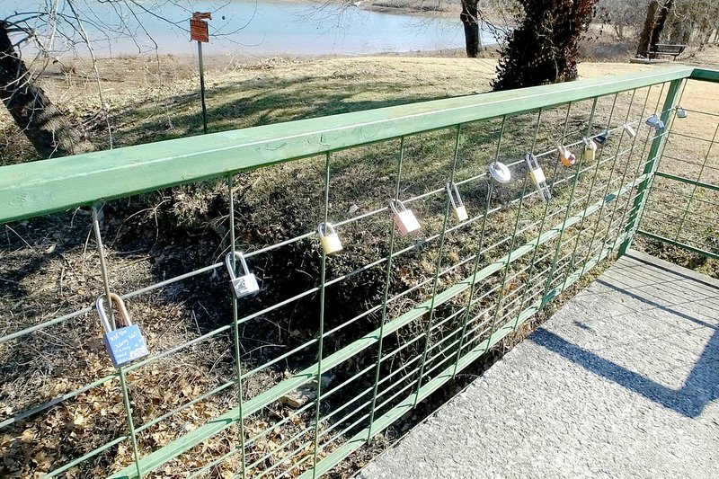 Lynn Atkins/The Weekly Vista "Locks of Love" hang on the bridge near the Bella Vista Dam. While not sanctioned by cities and parks, locks have begun appearing on bridges around the world, indicating a couple's permanent love relationship.