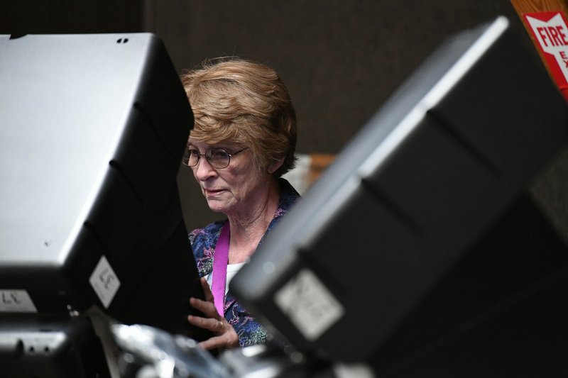NWA Democrat-Gazette/J.T. WAMPLER Edwina Gilmer of Springdale votes Tuesday at the Rodeo Community Center in Springdale. Voters considered a bond issue to fund a long list of projects in six ballot questions.