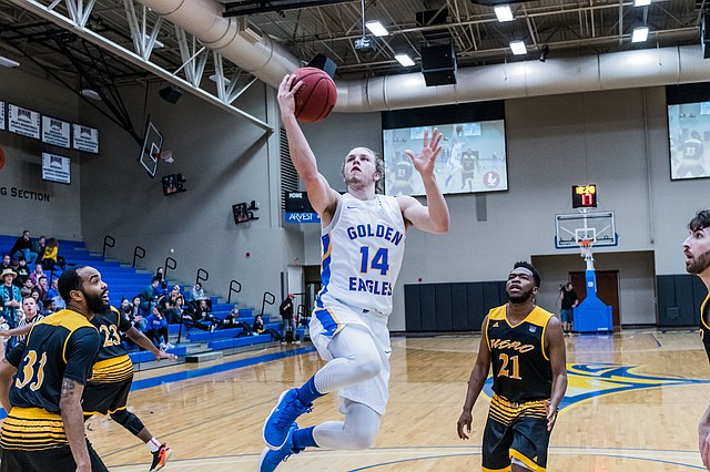 Photo courtesy of JBU Sports Information John Brown University's Jake Caudle soars in for two of his game-high 24 points during an 83-72 win against Science &amp; Arts (Okla.) at Bill George Arena on Saturday.