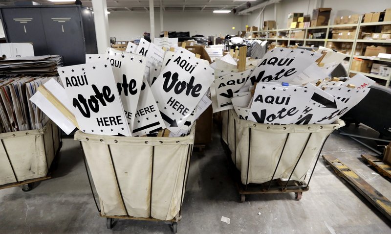 Bins of signs are seen in a storage are at the Bear County Election offices, Tuesday, Feb. 13, 2018, in San Antonio. The first primaries of the 2018 elections are less than a month away, but efforts to safeguard the vote against expected Russian interference are lagging. Texas will hold the first primary of 2018 on March 6. (AP Photo/Eric Gay)
