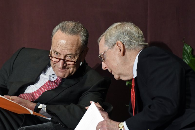 Senate Minority Leader Charles Schumer, D-N.Y., left, talks with Senate Majority Leader Mitch McConnell, R-Ky., before his speech at the McConnell Center's Distinguished Speaker Series Monday, Feb. 12, 2018, in Louisville, Ky. (AP Photo/Timothy D. Easley)