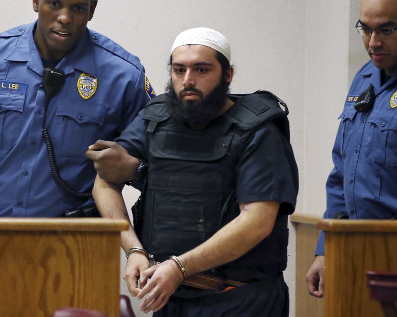 FILE - In this Dec. 20, 2016, file photo, Ahmad Khan Rahimi, center, is led into court in Elizabeth, N.J. Rahimi, who set off small bombs on a New York City street and at a charity race in New Jersey, is set to be sentenced to a mandatory term of life in prison. He is scheduled to be sentenced Tuesday, Feb. 13, 2018, by a federal judge in Manhattan. (AP Photo/Mel Evans, File)