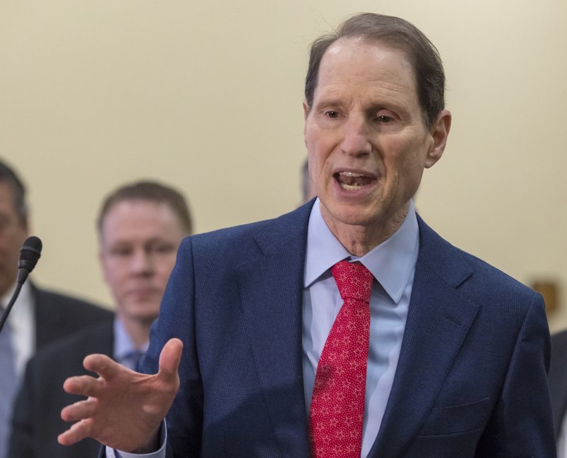 FILE - In this Jan. 10, 2018, file photo Sen. Ron Wyden, D-Ore., speaks at the Capitol in Washington. Some Medicare beneficiaries would face higher prescription drug costs under President Donald Trump's budget even as the sickest patients save money. That may make it harder to sell the complex plan to Congress in an election year. (AP Photo/J. Scott Applewhite, File)