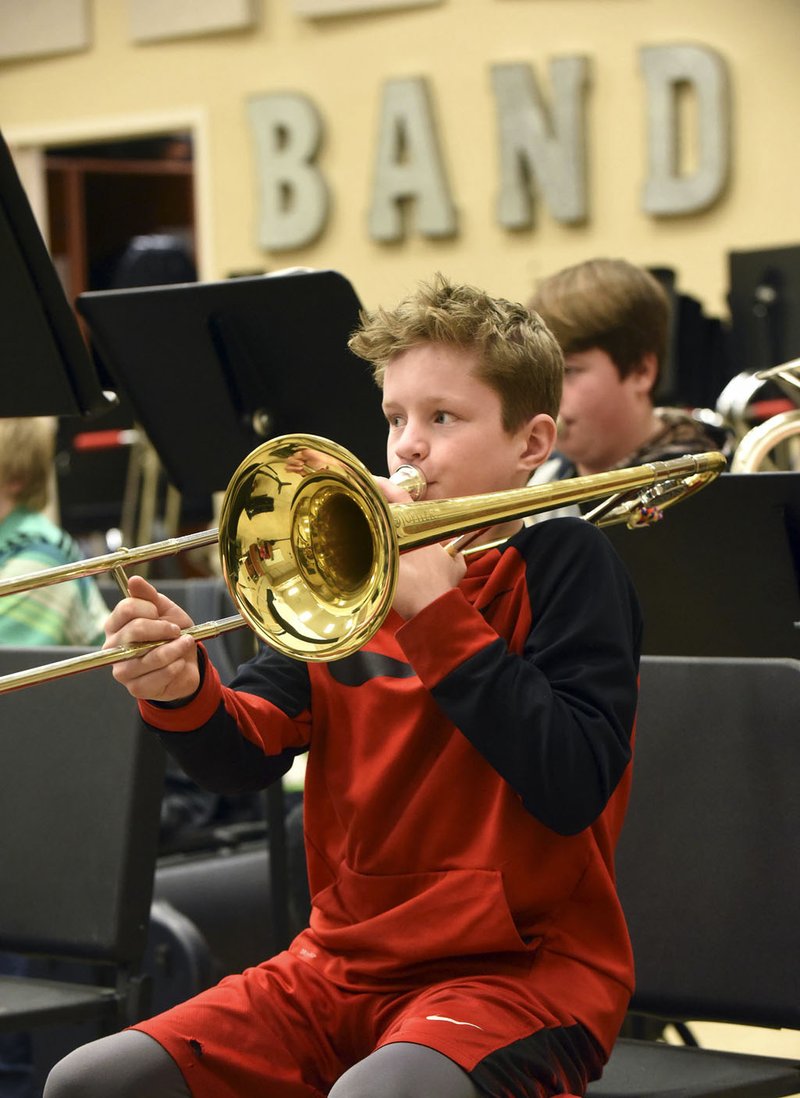 NWA Democrat-Gazette/FLIP PUTTHOFF Colton Neal plays trombone on Tuesday during a music class at Pea Ridge High School. A millage election held Tuesday to pay for a new high school was approved by voters.