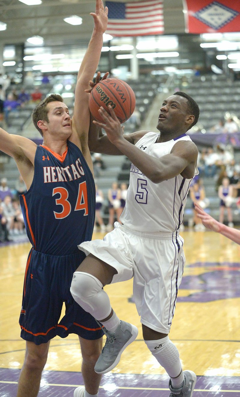NWA Democrat-Gazette/ANDY SHUPE
Darius Bowers (5) of Fayetteville fights through Rogers Heritage's Seth Stanley for a layup attempt Tuesday at Bulldog Arena in Fayetteville. Visit nwadg.com/photos for more photos from the game.