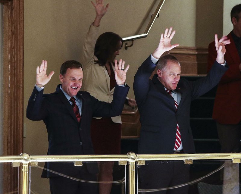 University of Arkansas, Fayetteville head football coach Chad Morris (left) and UA Athletic Director Hunter Yurachek join in calling the Hogs from the gallery of the state House chamber before Wednesday’s session. 